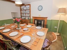 A dining room with a wooden table set for dinner at Town Mill in Bewdley