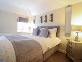 A bedroom with a bed and nightstand at Moelfre Cottage in Llanbedr