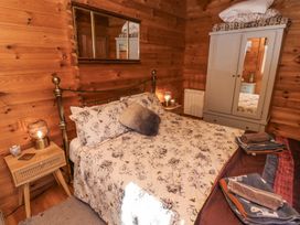 A bedroom with a double bed bedside tables lamps and a wardrobe in Aurora Skies in Cresswell near Morpeth