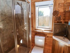 A bathroom with a shower cabin toilet sink and window at Aurora Skies in Cresswell near Morpeth