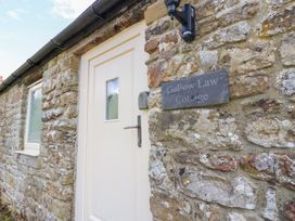 An entrance door with stone wall at Gallow Law Cottage in Bellingham