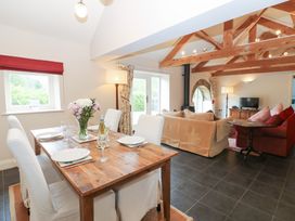 A living room with a dining area and seating at Gallow Law Cottage in Bellingham
