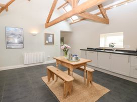 A kitchen with a table and benches at Gallow Law Cottage in Bellingham