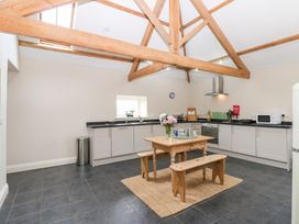 A kitchen with a table and benches at Gallow Law Cottage Bellingham