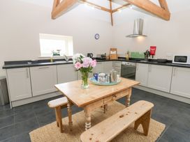 A kitchen with a dining table and sink at Gallow Law Cottage in Bellingham