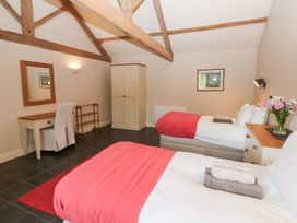A bedroom with two beds and a desk at Gallow Law Cottage in Bellingham