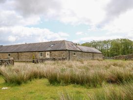 A house with grass and trees at Gallow Law Cottage in Bellingham