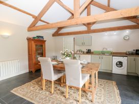 A kitchen with a dining table and chairs at Shepherds Burn Cottage in Bellingham