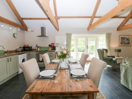A kitchen with a dining table set for four at Shepherds Burn Cottage in Bellingham