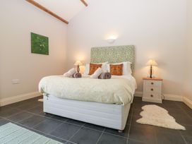 A bedroom with a bed and bedside table at Shepherds Burn Cottage in Bellingham