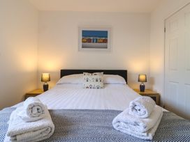 A bedroom with a bed and bedside tables at Keepers Cottage in Sidmouth