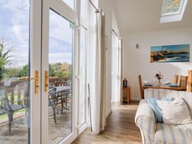 A dining room with a view and furniture at Keepers Cottage in Sidmouth