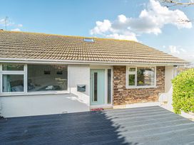 An exterior view of a house with a deck at Sunset View in Porth