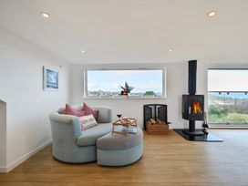 A living room with a sofa and fireplace at Sunset View in Porth