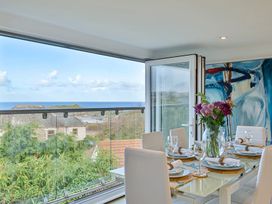 A dining room with a table set for meals at Sunset View in Porth