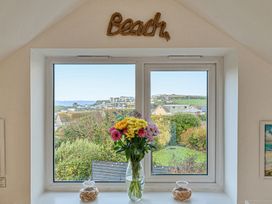 A window with flowers in a vase at Sunset View in Porth