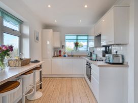 A kitchen with a sink and appliances at Sunset View in Porth