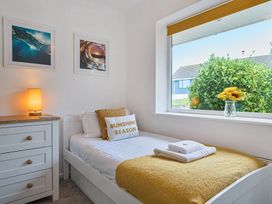 A bedroom with a bed and a chest of drawers at Sunset View in Porth