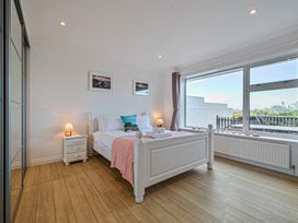 A bedroom with a bed and bedside table at Sunset View in Porth