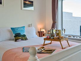 A bedroom with a bed and a tray on it at Sunset View in Porth