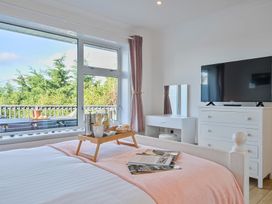 A bedroom with a bed and television at Sunset View in Porth