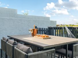 An outdoor dining area with a table and chairs at Sunset View in Porth