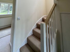 A staircase with handrail and window at Lodge 22, Bodmin Holiday Park, Cornwall