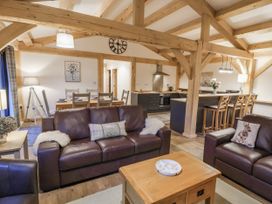 A living room with sofas and a dining table at Lady Bagots Cabin in Ruthin