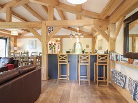 A living room with wooden beams and seating at Lady Bagots Cabin in Ruthin
