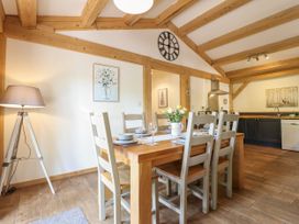 A dining room with a table and chairs at Lady Bagots Cabin in Ruthin