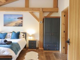 A bedroom with a bed and wardrobe at Lady Bagots Cabin in Ruthin