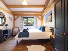 A bedroom with a bed and furniture at Lady Bagots Cabin in Ruthin