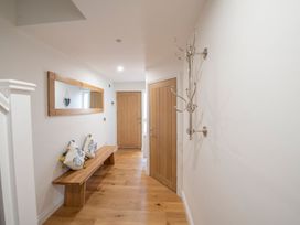 A hallway with a wooden bench and mirror at Harbour Sunset