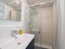 A bathroom with a shower and sink at Harbour Sunset