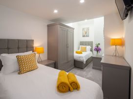 A bedroom with two beds and a wardrobe at Harbour Sunset