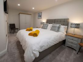 A bedroom with a double bed and wardrobe at Harbour Sunset