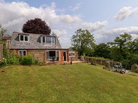 A house with gardens and trees at Mallows Byre in Yetminster