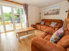 A living room with a sofa and coffee table at Mallows Byre in Yetminster