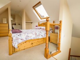 A bedroom with a bed and dresser at Mallows Byre in Yetminster