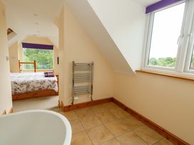A bedroom with a bed and a radiator at Mallows Byre in Yetminster