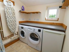 A laundry room with washing machine and tumble dryer at Mallows Byre in Yetminster
