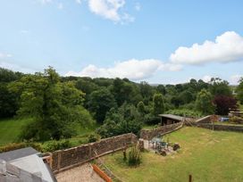 An outdoor view with trees and a garden area at Mallows Byre in Yetminster