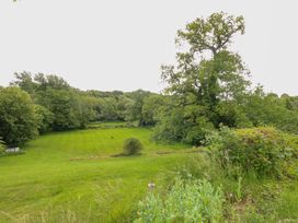 An outdoor area with trees and a grass field at Mallows Byre Yetminster