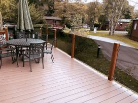 An outdoor dining area with a table and chairs at Coniston Number 9 White Cross Bay