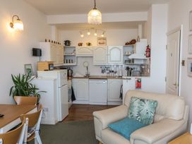 A kitchen with appliances and dining area at Close to Shore 
