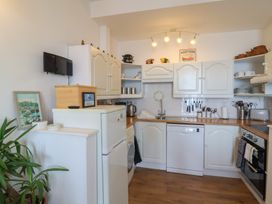 A kitchen with appliances and storage at Close to Shore