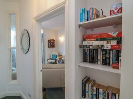 A hallway with a bookcase and a mirror at Close to Shore 