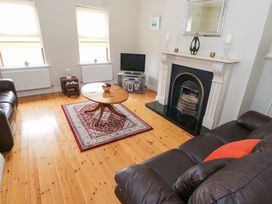 A living room with a coffee table and television at Aisling in Foxford near Ballina, County Mayo