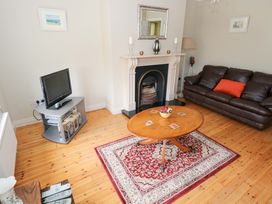 A living room with a television and sofa at Aisling in Foxford near Ballina, County Mayo
