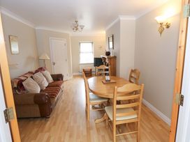 A living room with a sofa and dining furniture at Aisling in Foxford near Ballina, County Mayo